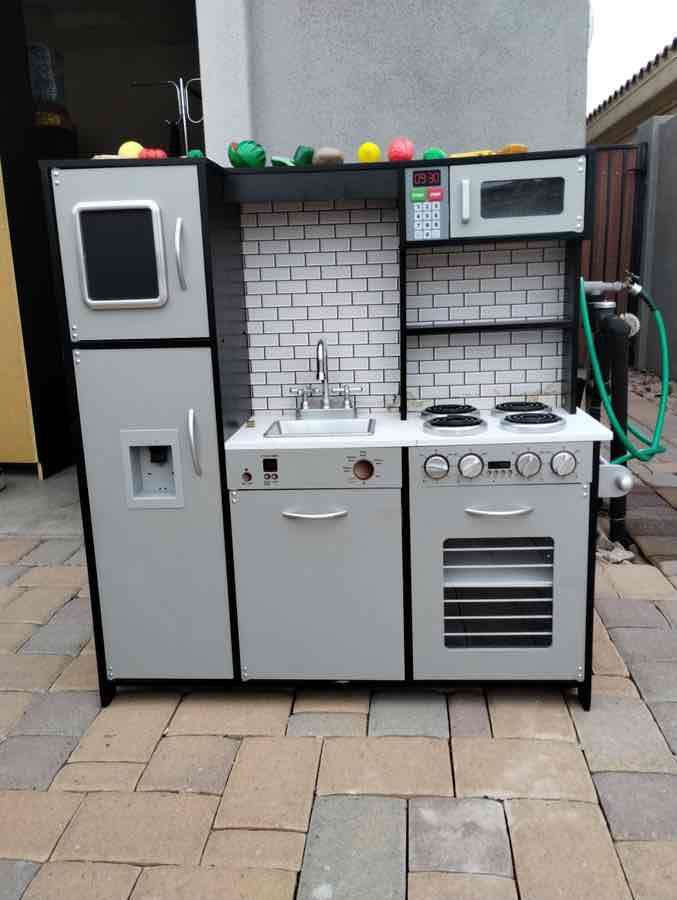 Child”s black and silver Wooden kitchen with accessories
